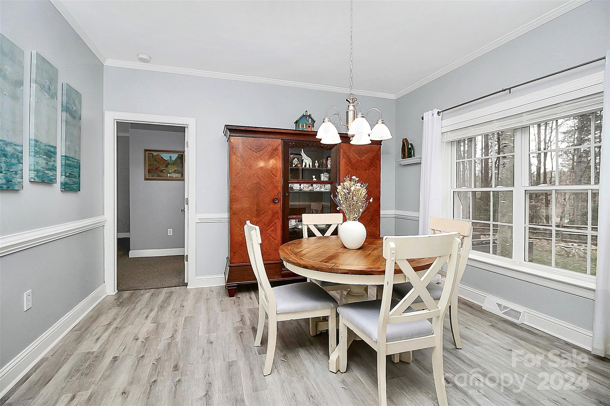 218 Stillwater Road Troutman, NC 28166 - Photo 22 of 43 a dining room with furniture a chandelier and wooden floor