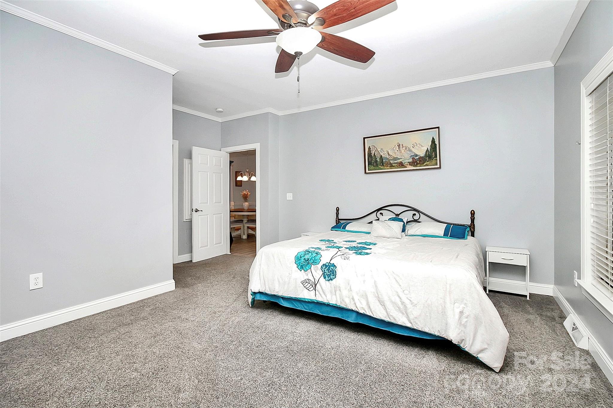 218 Stillwater Road Troutman, NC 28166 - Photo 23 of 43 a spacious bedroom with a bed and a ceiling fan