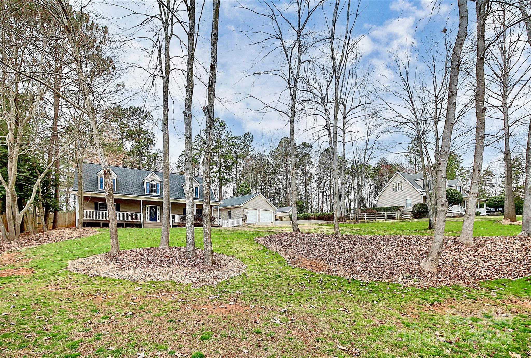 218 Stillwater Road Troutman, NC 28166 - Photo 3 of 43 a view of a park with a house and a trees