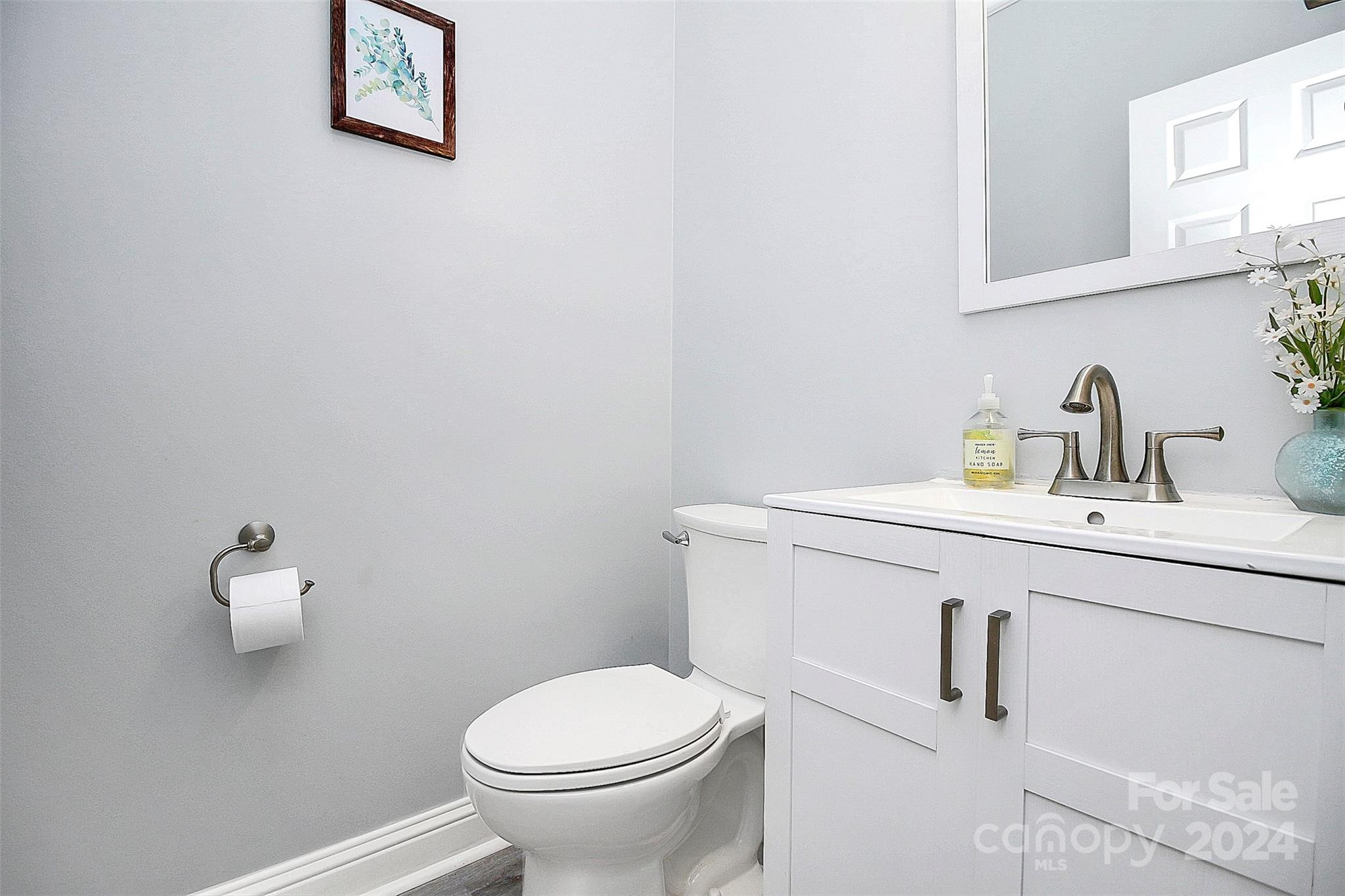 218 Stillwater Road Troutman, NC 28166 - Photo 33 of 43 a bathroom with a toilet sink and mirror