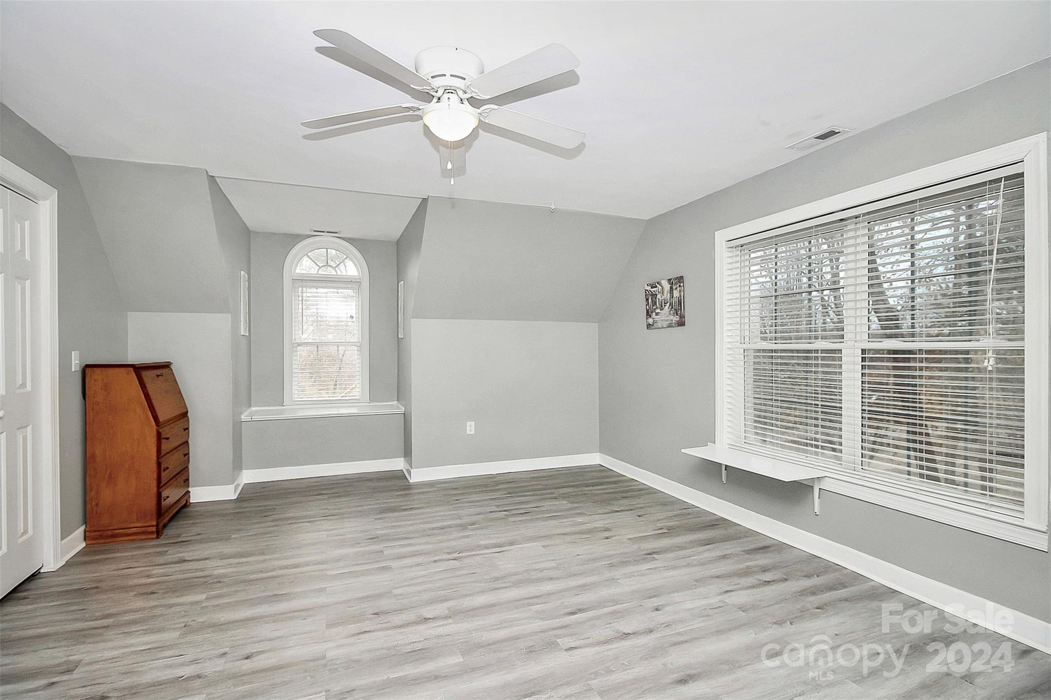 218 Stillwater Road Troutman, NC 28166 - Photo 35 of 43 an empty room with wooden floor and windows