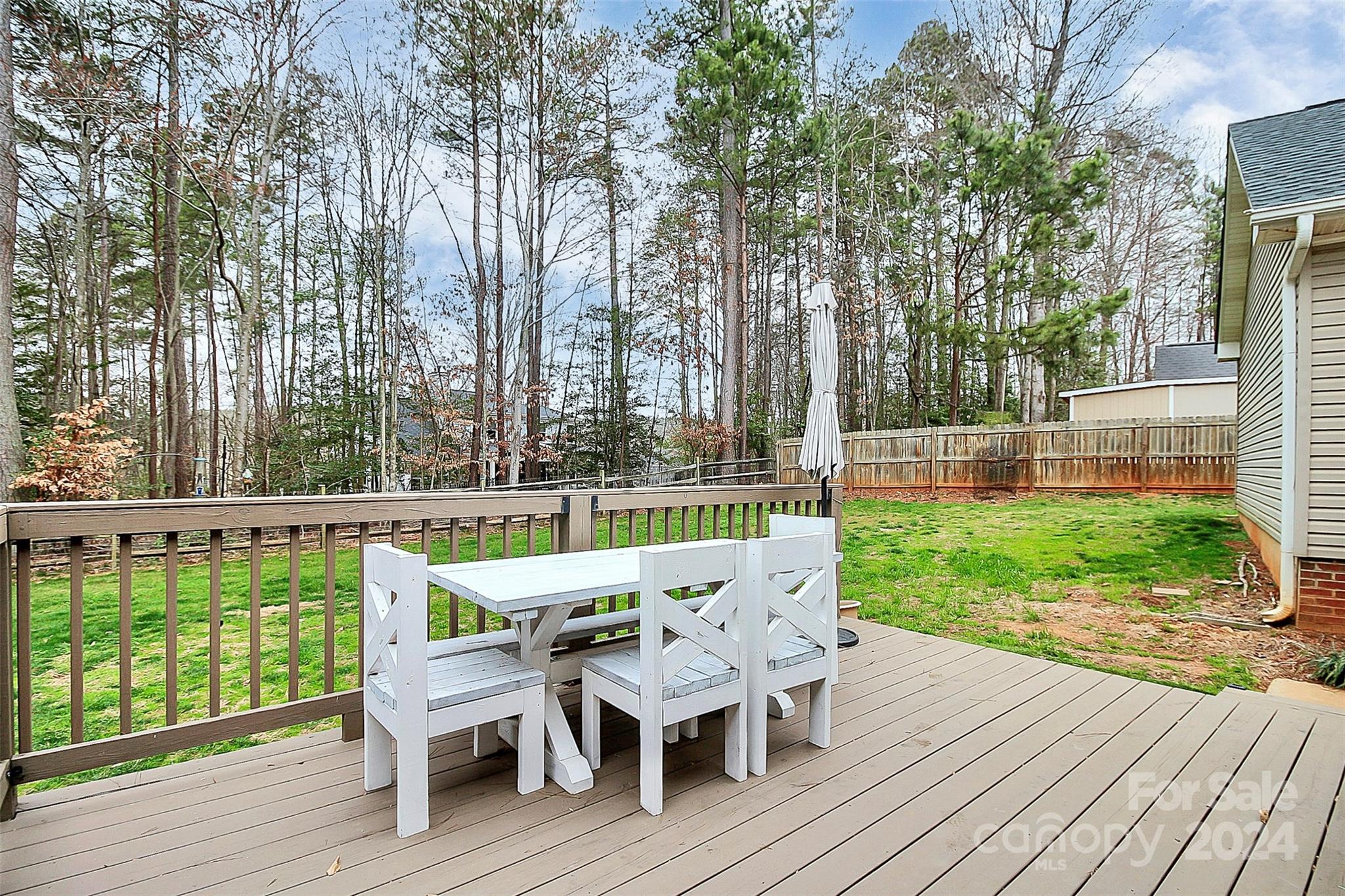 218 Stillwater Road Troutman, NC 28166 - Photo 4 of 43 a view of a chair and table on the wooden deck