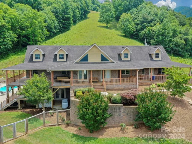 a aerial view of a house with a yard and potted plants