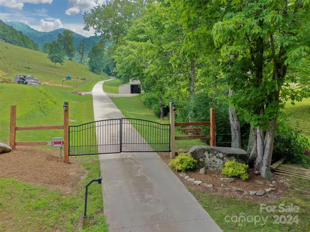 a green field with trees in the background