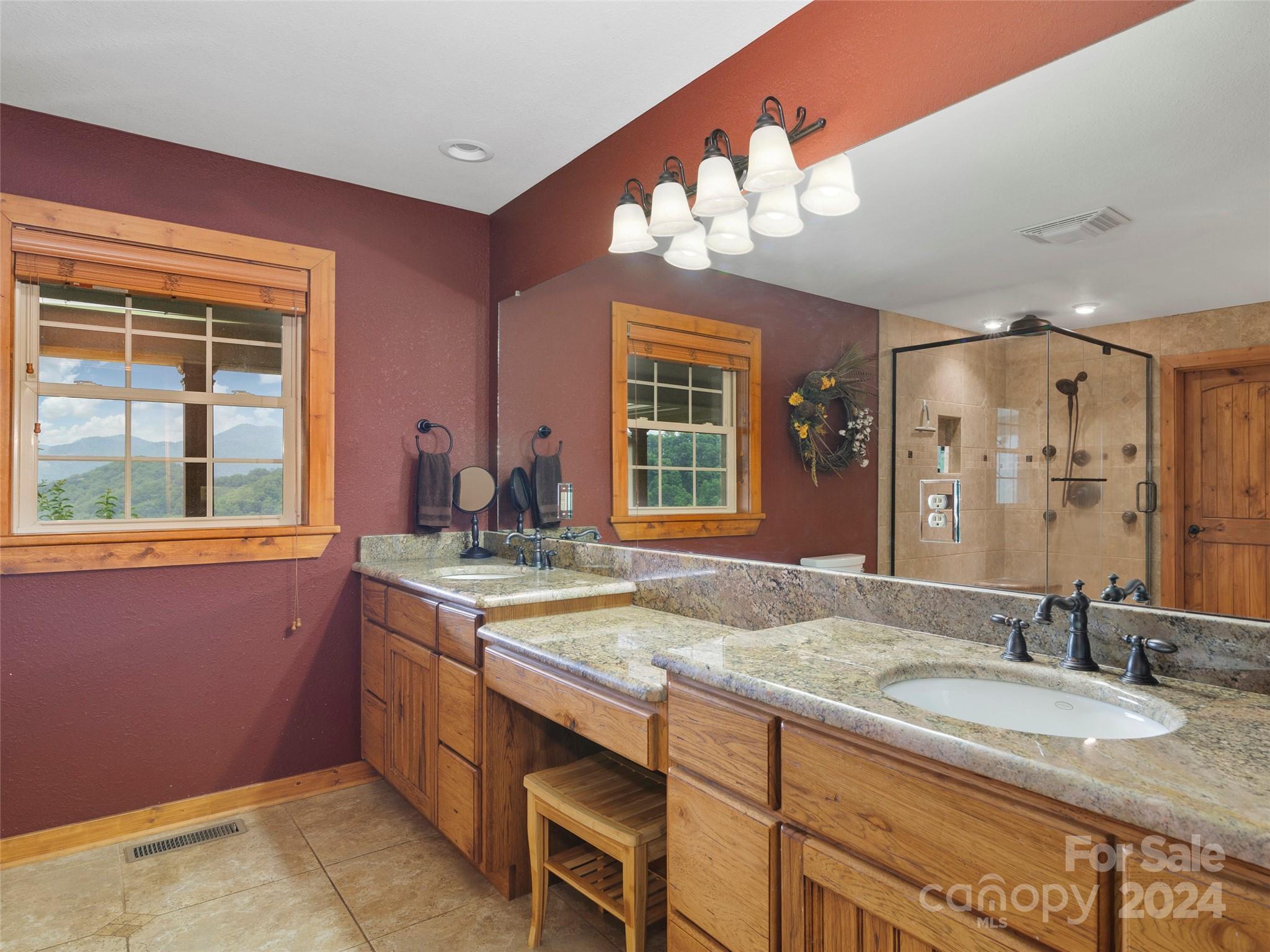 317 Camp Branch Road Clyde, NC 28721 - Photo 20 of 47 a bathroom with a granite countertop sink and a large mirror