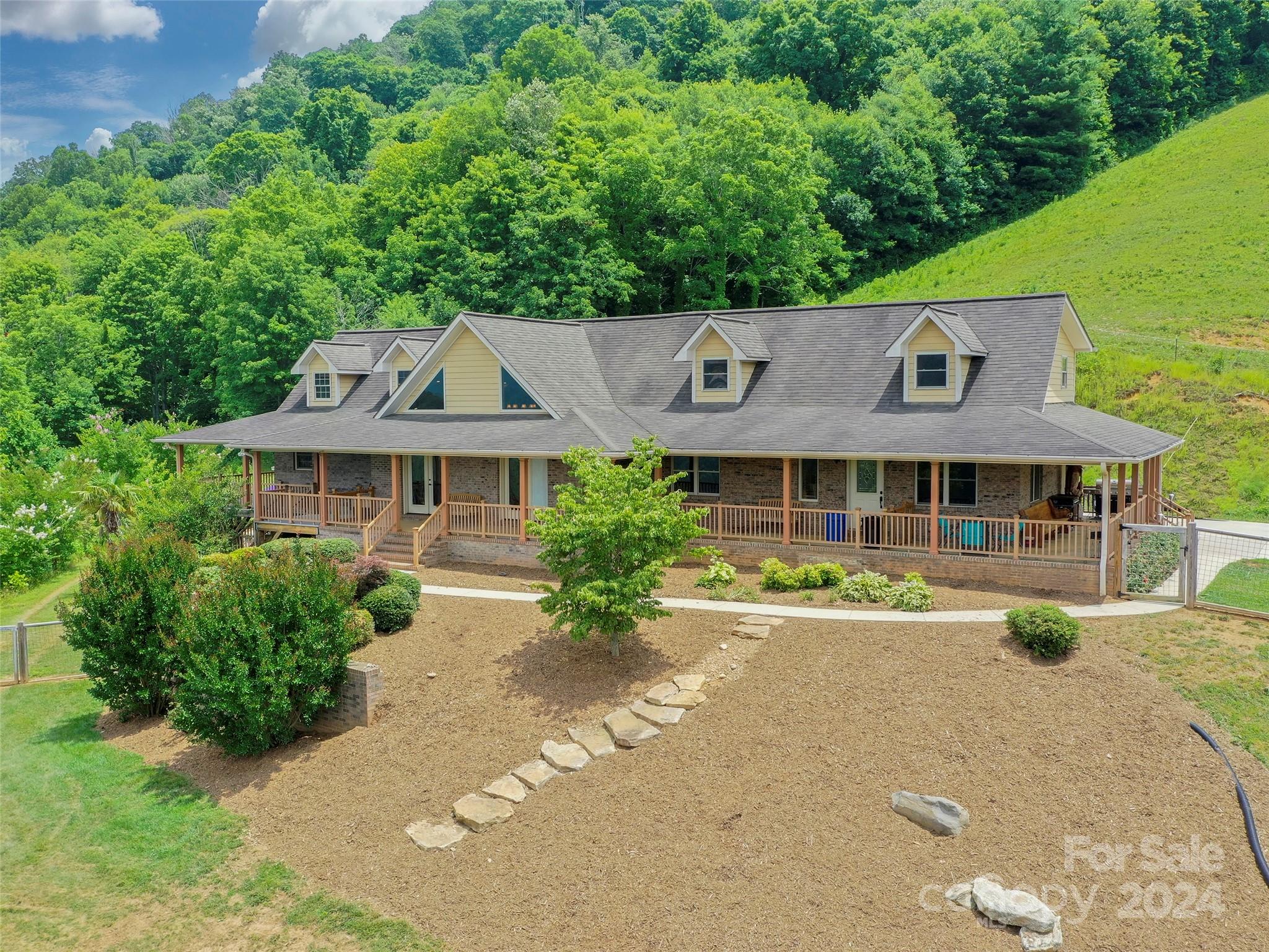 317 Camp Branch Road Clyde, NC 28721 - Photo 2 of 47 an aerial view of a house with a yard