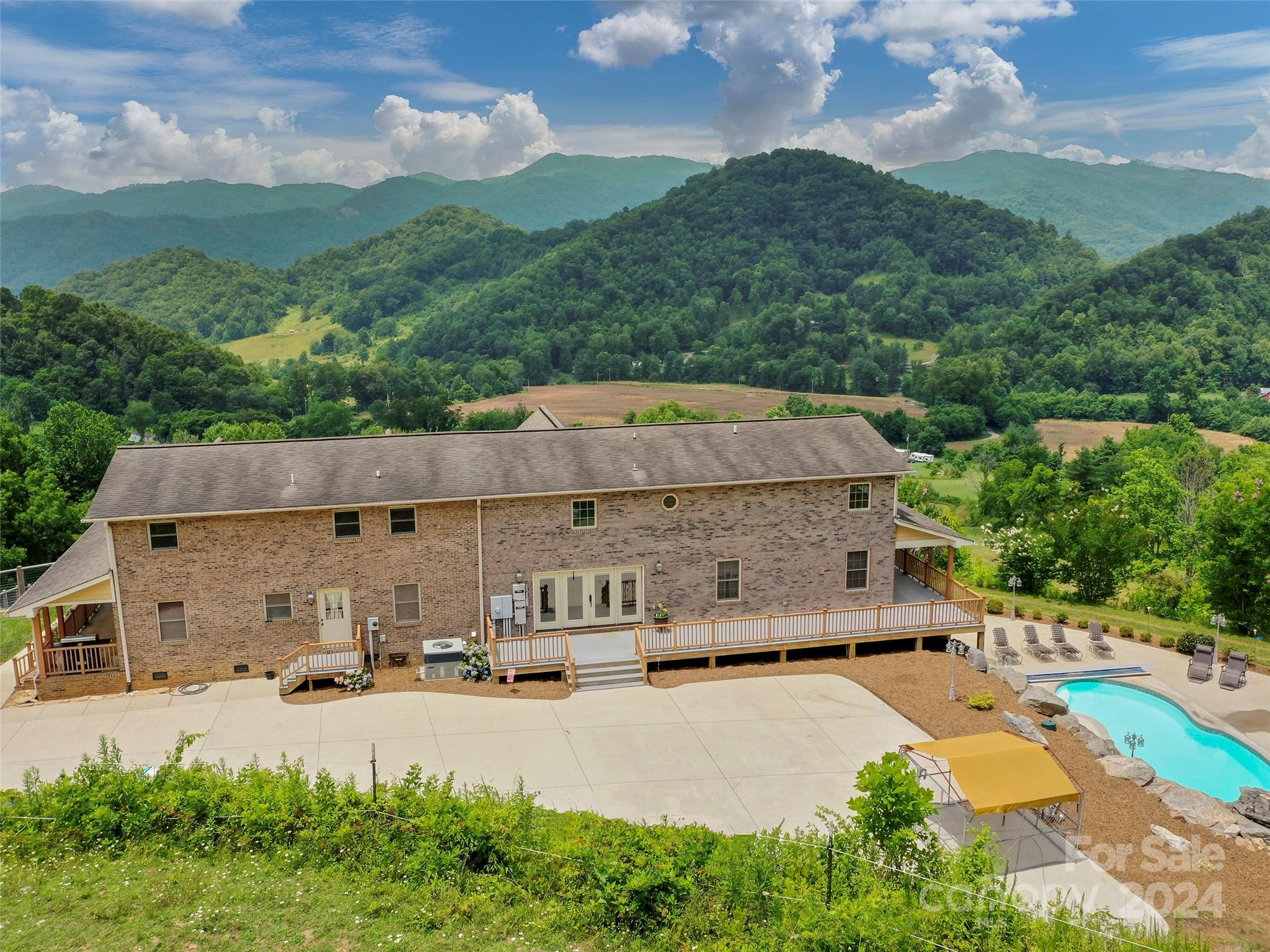 317 Camp Branch Road Clyde, NC 28721 - Photo 21 of 47 an aerial view of a house with a garden and a yard