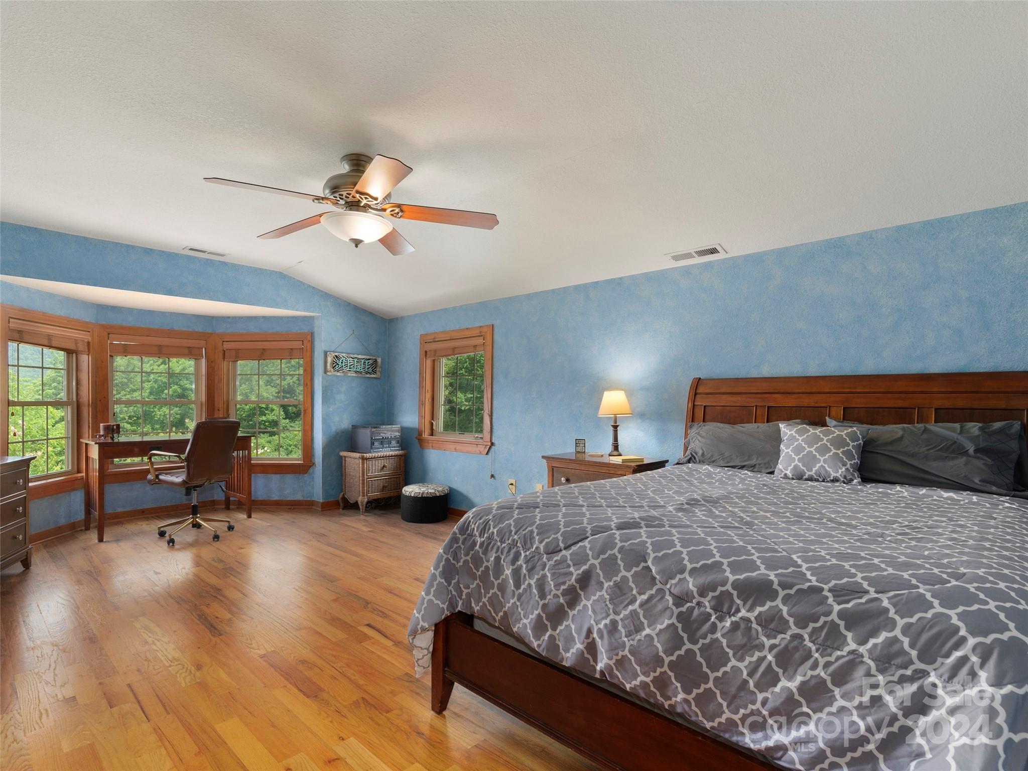 317 Camp Branch Road Clyde, NC 28721 - Photo 30 of 47 a bedroom with a large bed and a large window