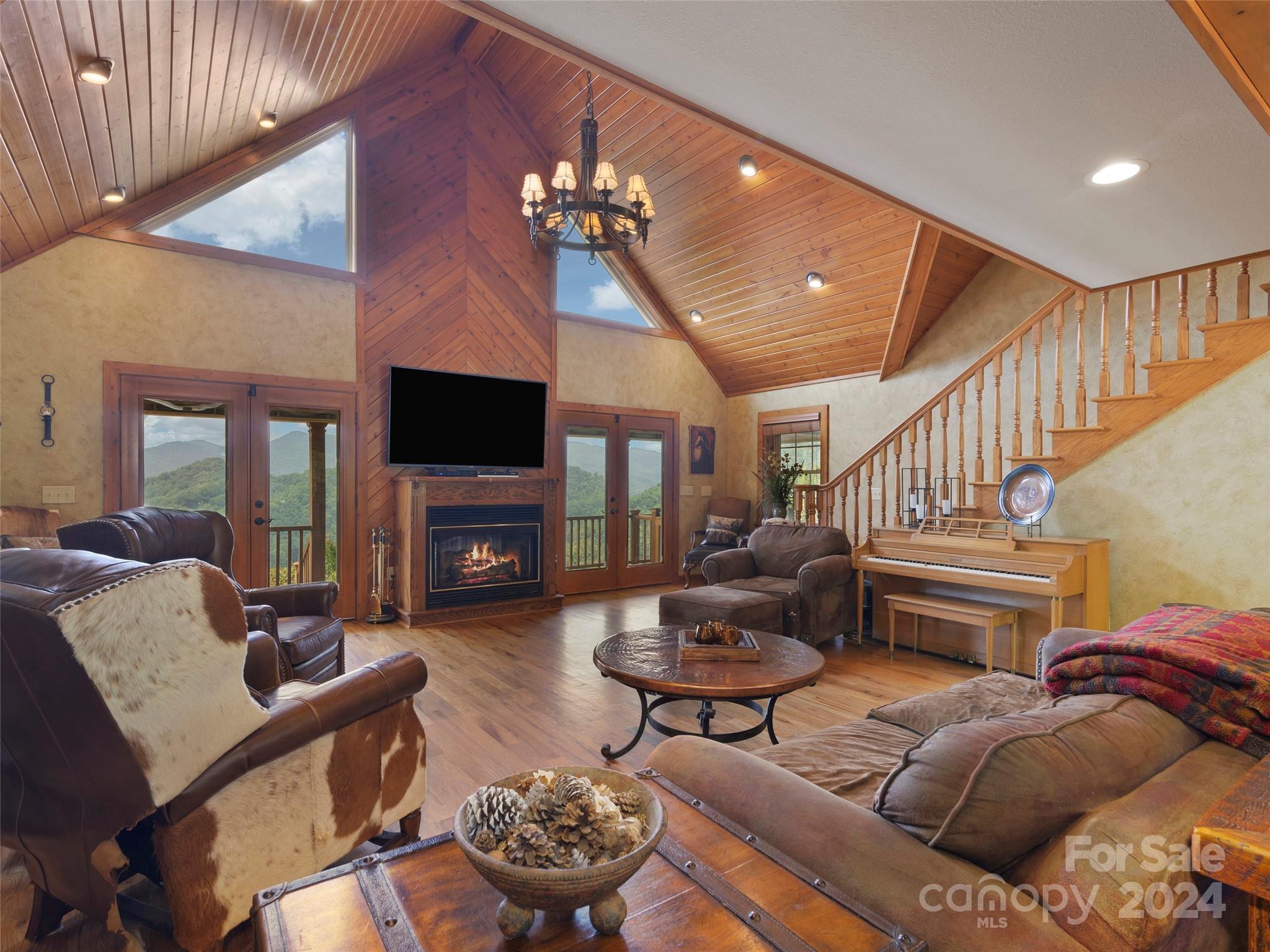 317 Camp Branch Road Clyde, NC 28721 - Photo 38 of 47 a living room with furniture a flat screen tv and a fireplace