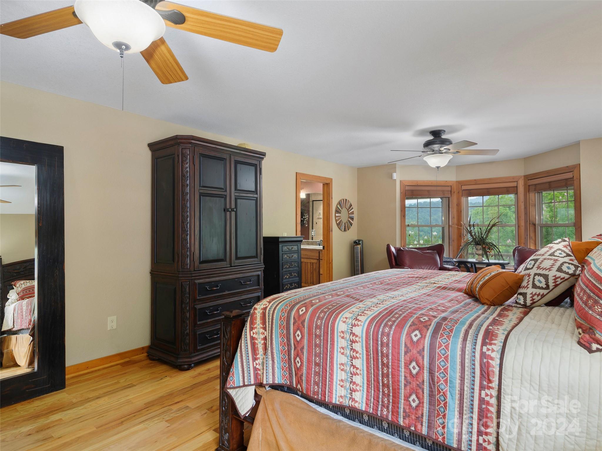 317 Camp Branch Road Clyde, NC 28721 - Photo 39 of 47 a bedroom with a bed and a chandelier