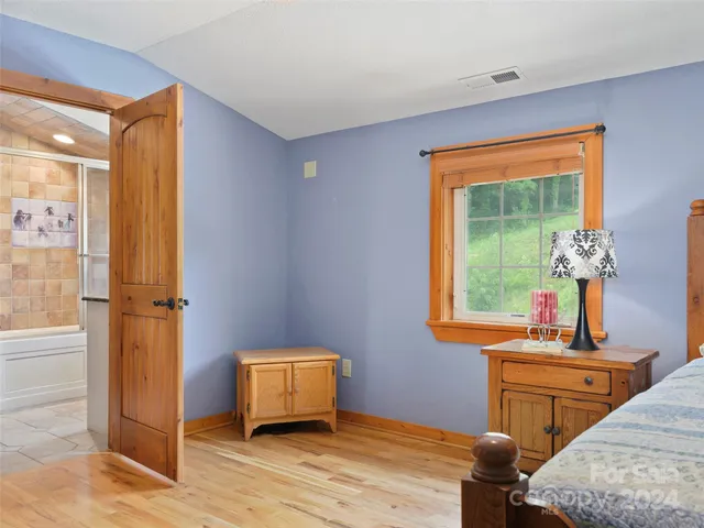 a bathroom with a granite countertop sink mirror and shower