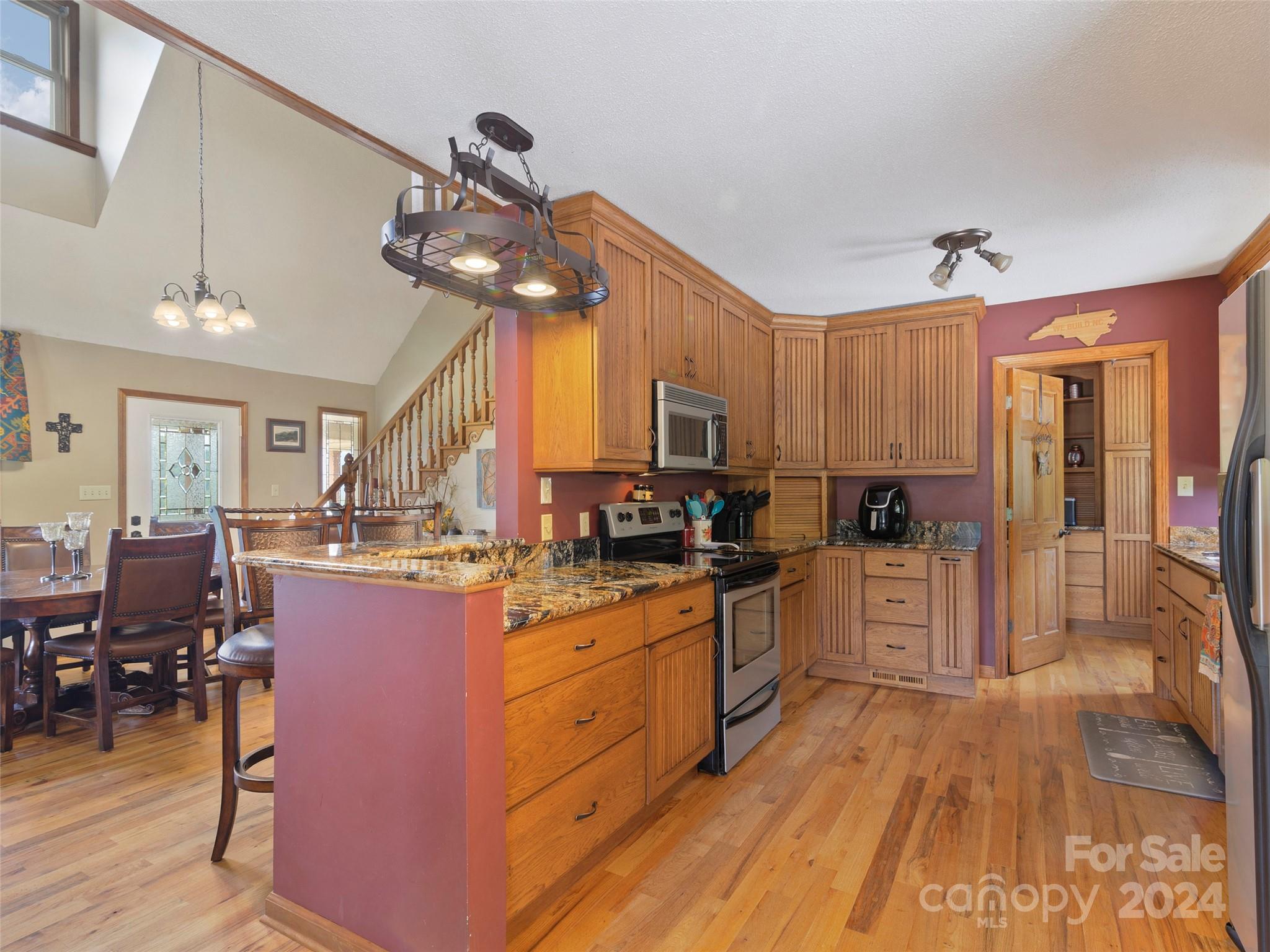 317 Camp Branch Road Clyde, NC 28721 - Photo 6 of 47 a kitchen with stainless steel appliances granite countertop a stove refrigerator and cabinets