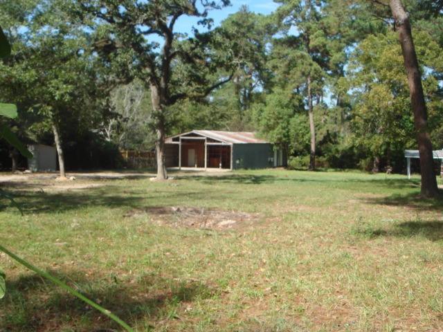 4018 East Mossy Oaks Road Spring, TX 77389 - Photo 16 of 23 a view of a house with a yard