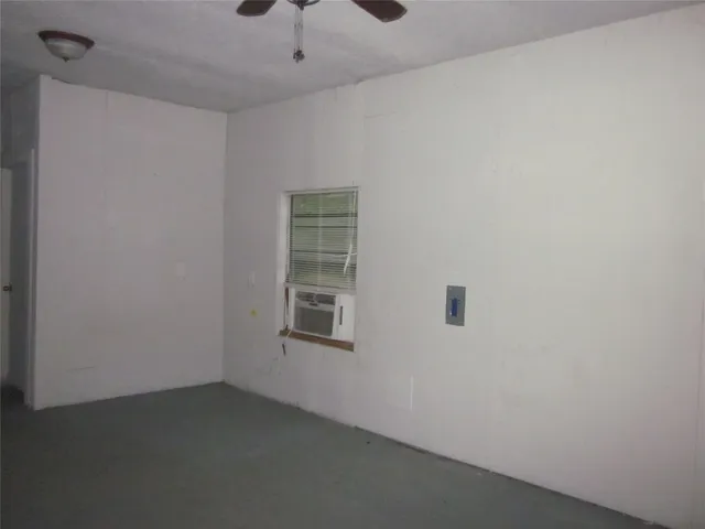 an empty room with a empty space and windows