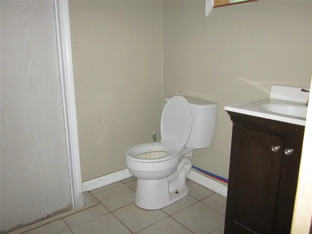 a white toilet sitting next to a bathroom sink