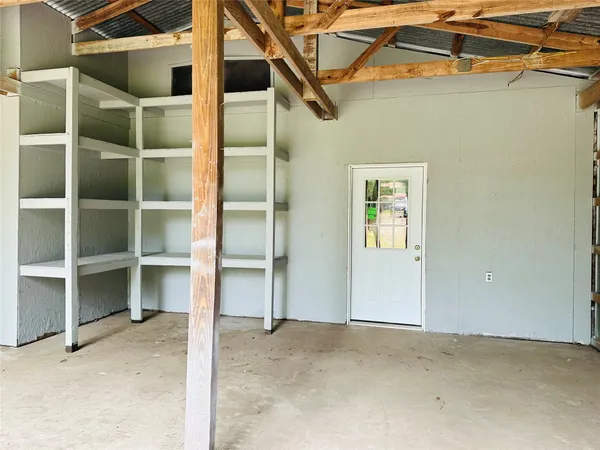 a view of an empty room with a cabinet and a window