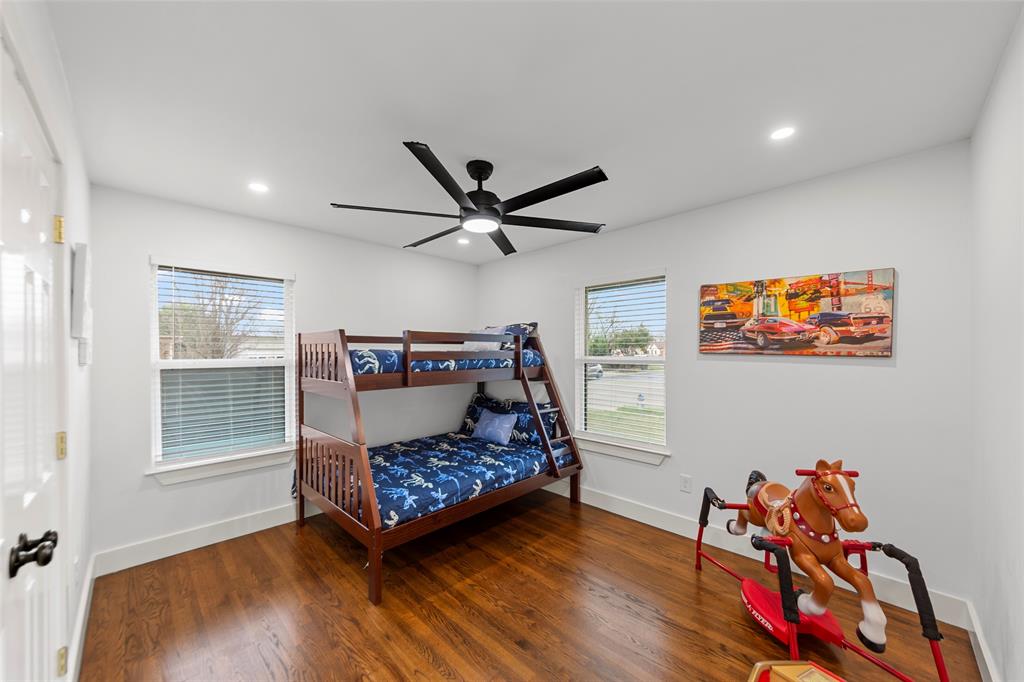 2945 Healey Drive Dallas, TX 75228 - Photo 24 of 38 a room with wooden floor and a ceiling fan