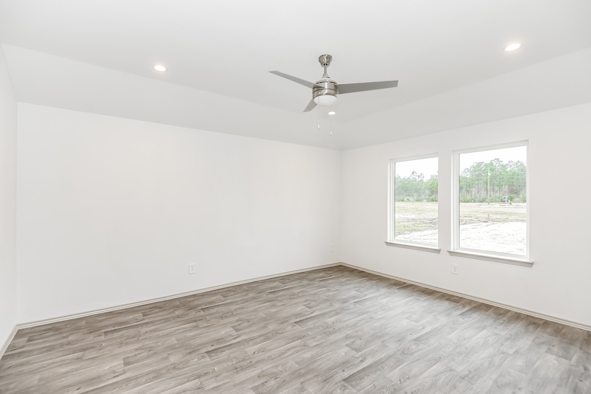 555 Hunter Grove Lane China, TX 77613 - Photo 19 of 21 an empty room with wooden floor fan and windows