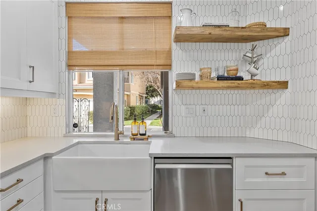 a kitchen with stainless steel appliances a sink stove and window