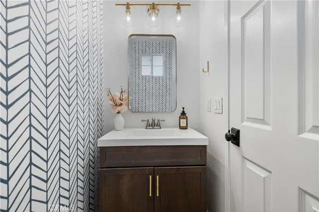 a bathroom with a sink a mirror and a shower