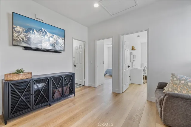 a view of a hallway with wooden floor and furniture