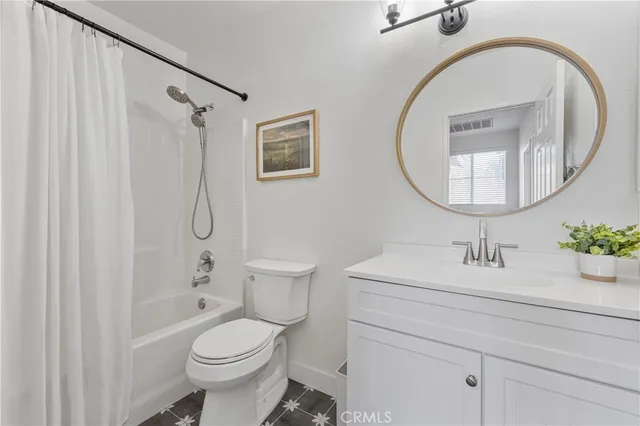 a bathroom with a sink a mirror a toilet and a shower