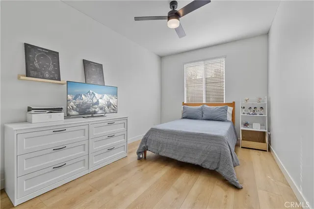 a bedroom with a bed window and a dresser