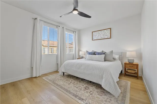 a bedroom with a bed chandelier and a window