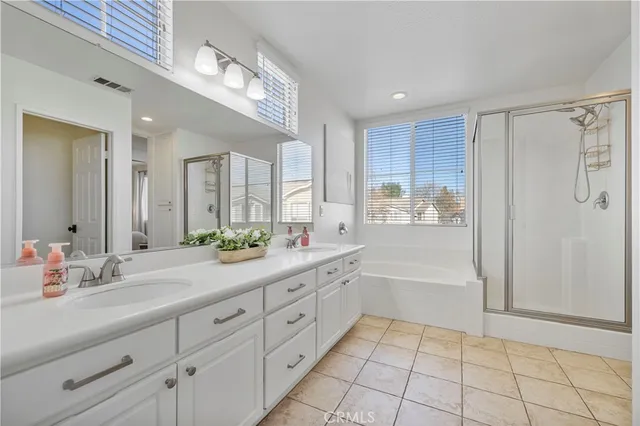 a spacious bathroom with a shower a sink and a mirror