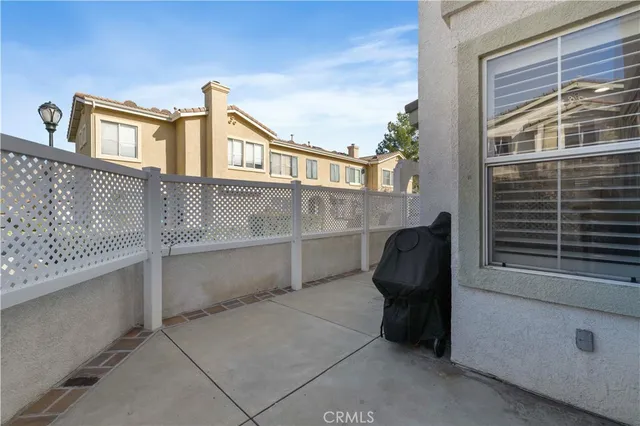 a view of a house with a large window and chair