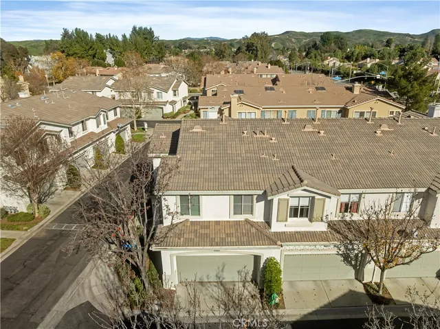 an aerial view of houses with a city view