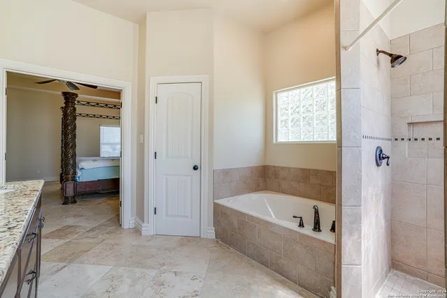a bathroom with a bathtub and a shower