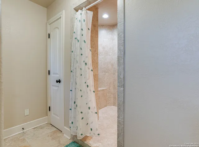 a bathroom with a shower and a glass door