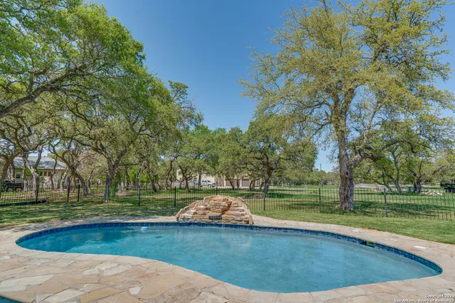 a view of a swimming pool and a yard