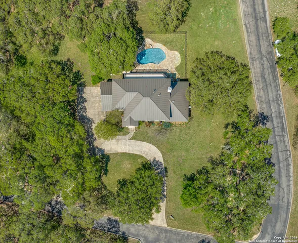 an aerial view of a house with a yard