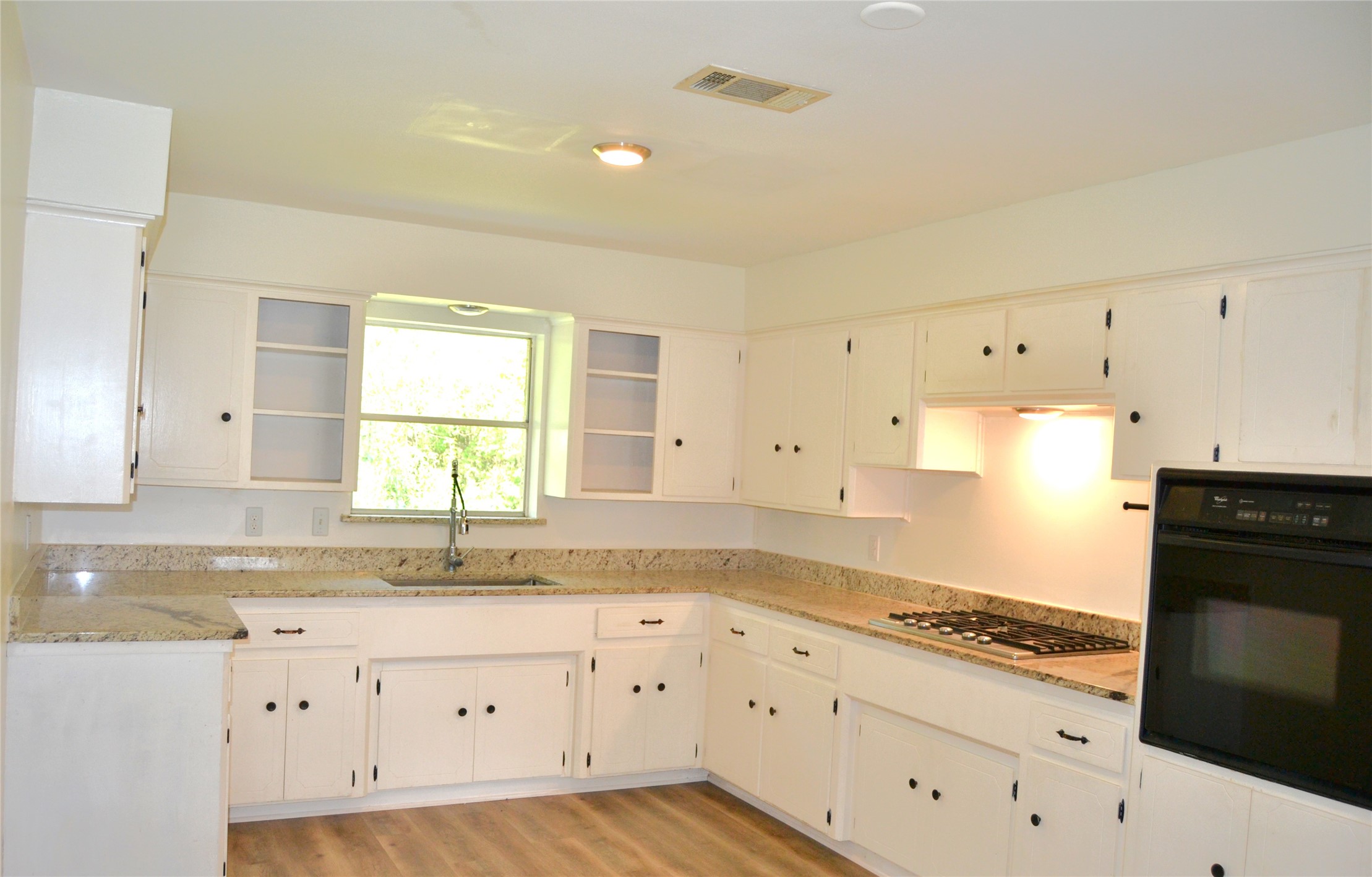 101 Summit Drive Conroe, TX 77303 - Photo 5 of 24 a kitchen with granite countertop white cabinets and white appliances