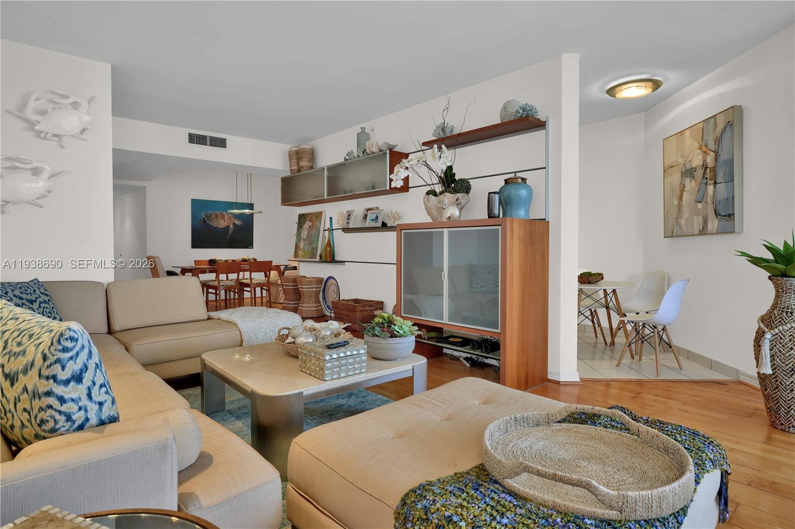 4779 Collins Avenue, Unit 3104 Miami Beach, FL 33140 - Photo 12 of 61 a living room with furniture and a flat screen tv