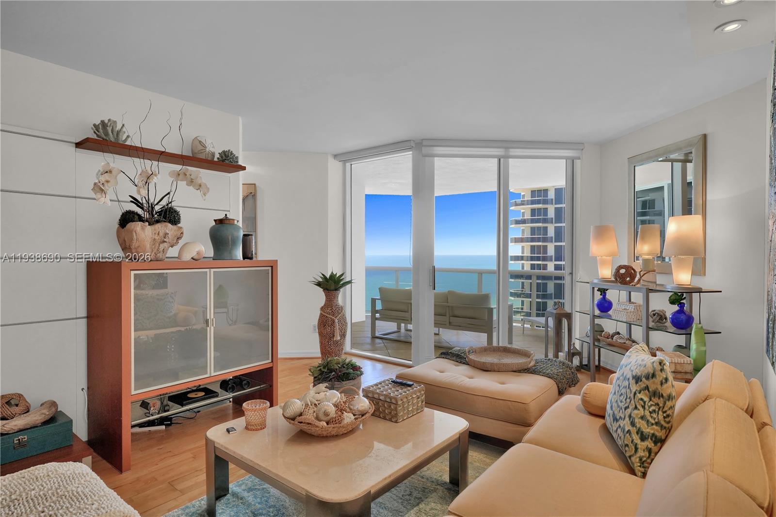4779 Collins Avenue, Unit 3104 Miami Beach, FL 33140 - Photo 13 of 61 a living room with furniture and a floor to ceiling window