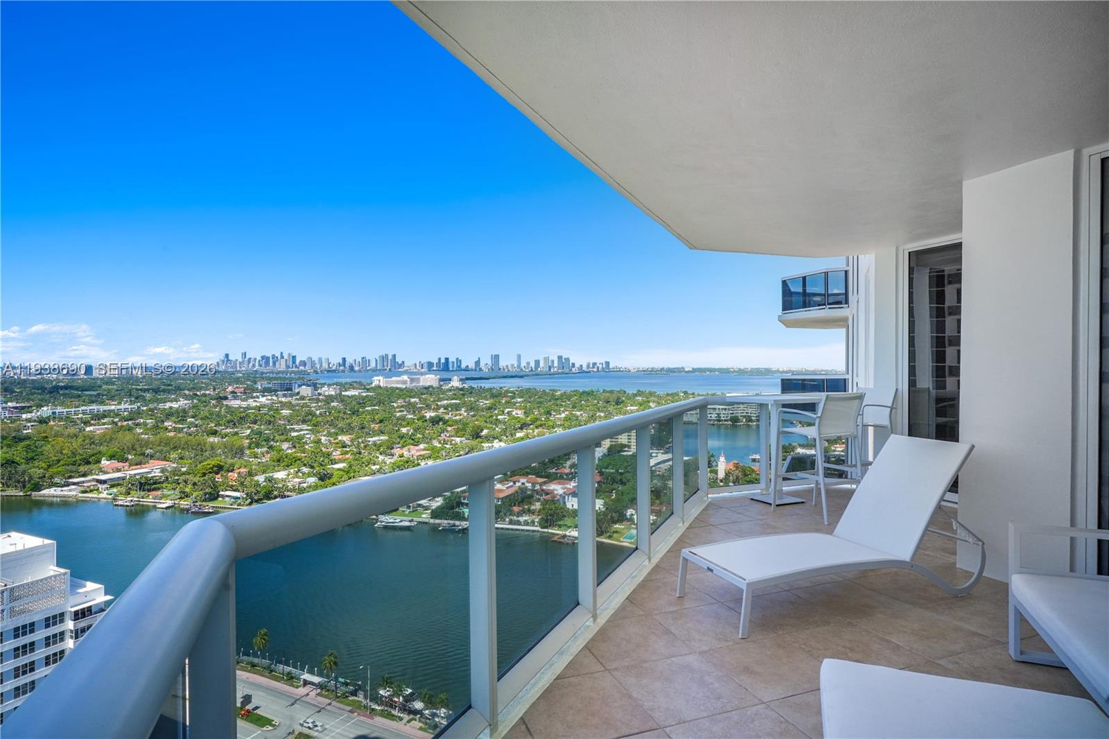4779 Collins Avenue, Unit 3104 Miami Beach, FL 33140 - Photo 18 of 61 a view of a chairs and table in the balcony