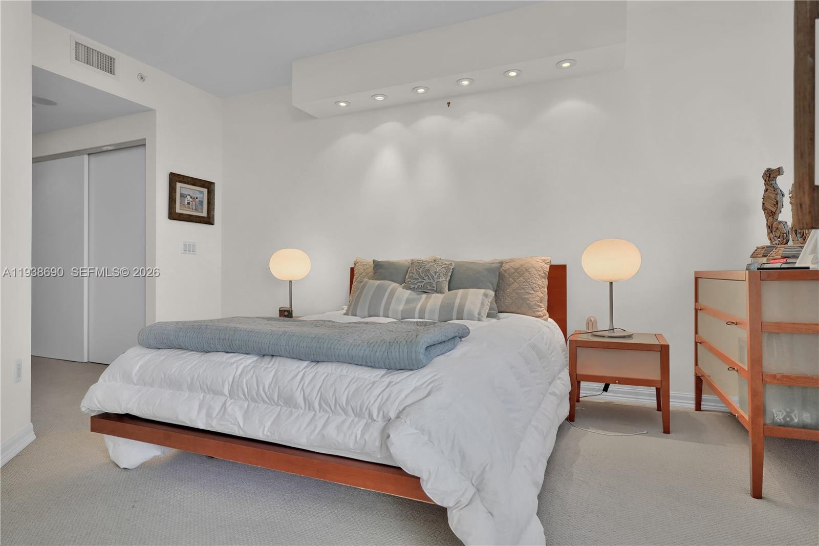 4779 Collins Avenue, Unit 3104 Miami Beach, FL 33140 - Photo 24 of 61 a bedroom with a bed and a lamp