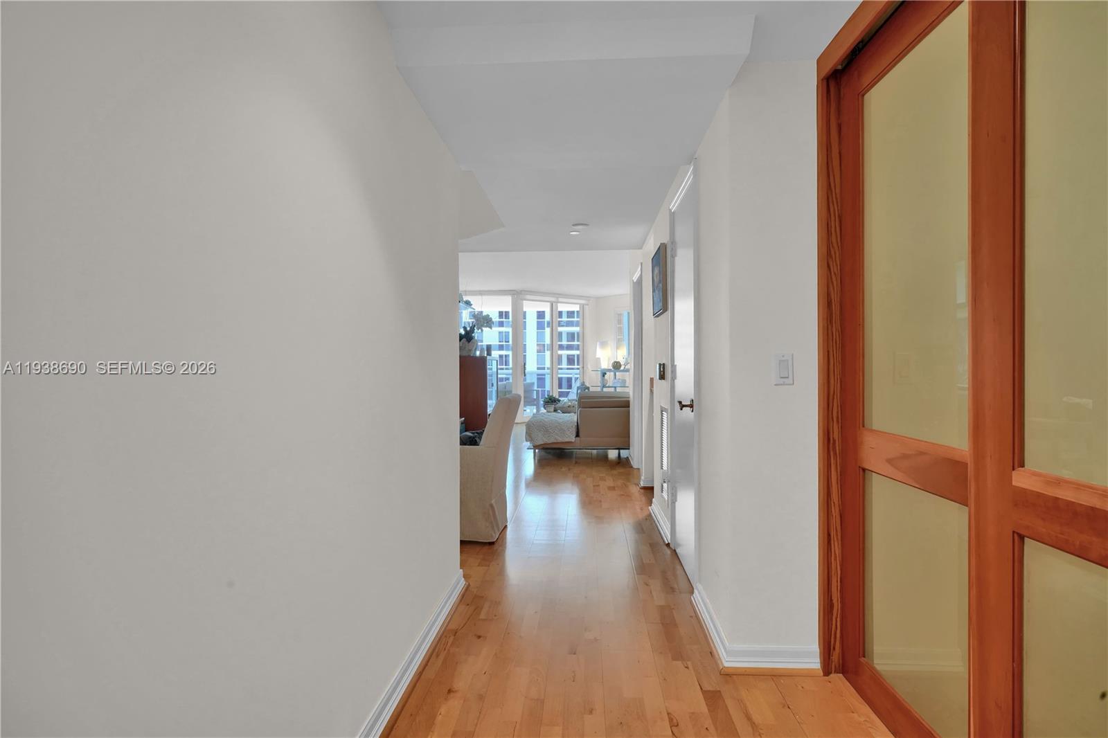 4779 Collins Avenue, Unit 3104 Miami Beach, FL 33140 - Photo 3 of 61 a view of a hallway with wooden floor and a living room