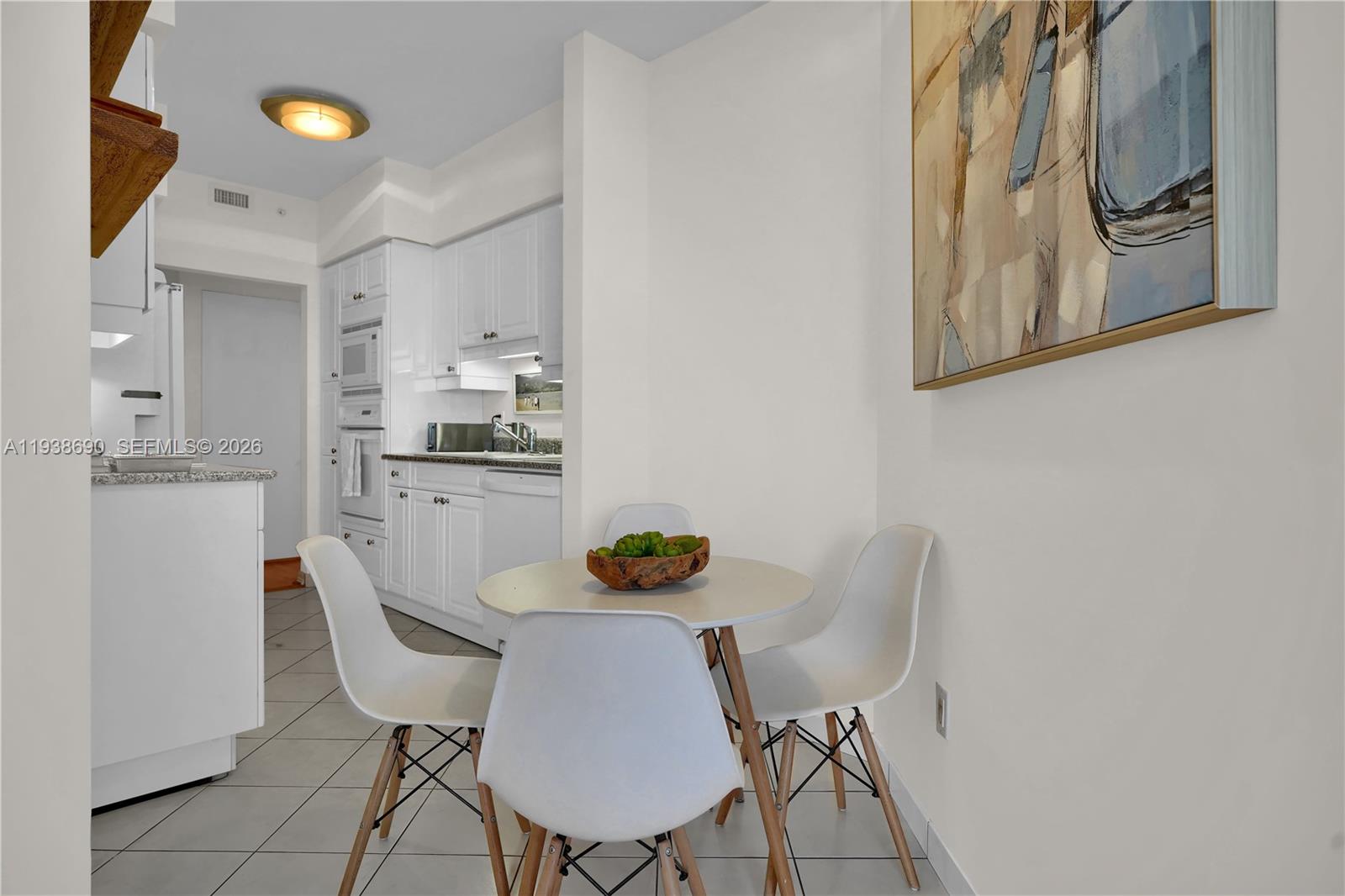 4779 Collins Avenue, Unit 3104 Miami Beach, FL 33140 - Photo 31 of 61 a view of a dining room with furniture and wooden floor