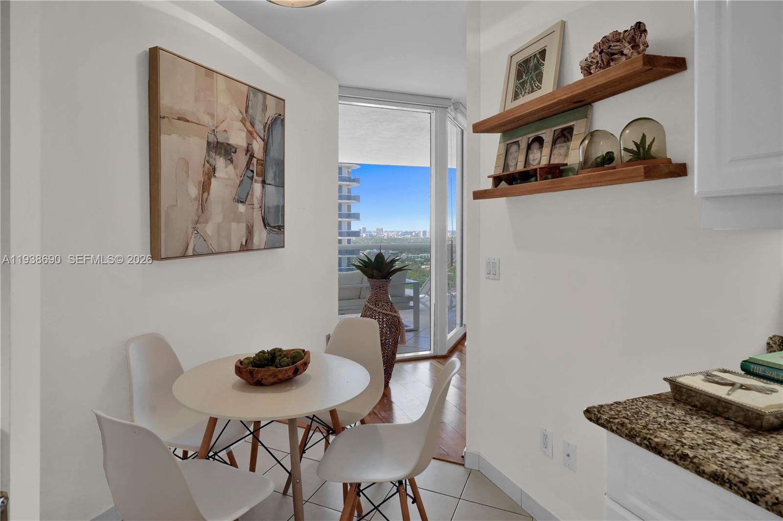 4779 Collins Avenue, Unit 3104 Miami Beach, FL 33140 - Photo 32 of 61 a view of a dining room with furniture and wooden floor
