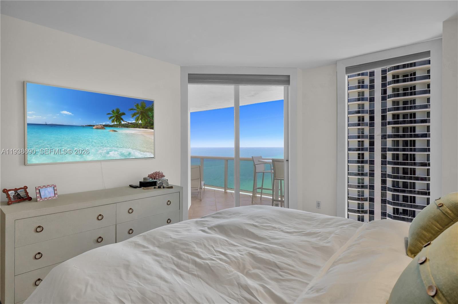 4779 Collins Avenue, Unit 3104 Miami Beach, FL 33140 - Photo 36 of 61 a bedroom with a bed and a window