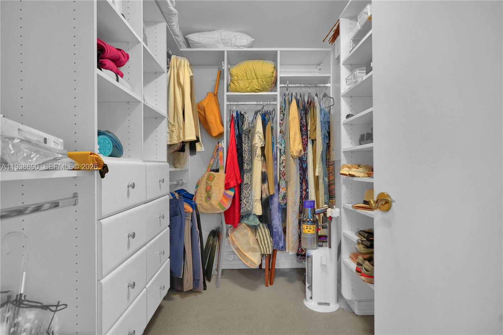 4779 Collins Avenue, Unit 3104 Miami Beach, FL 33140 - Photo 38 of 61 a view of walk in closet with clothes