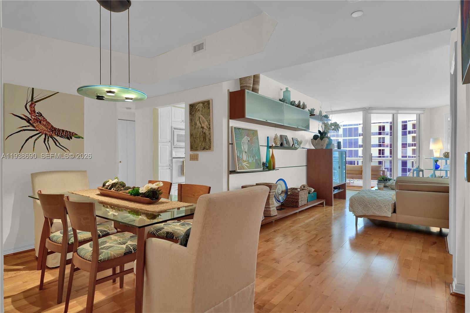 4779 Collins Avenue, Unit 3104 Miami Beach, FL 33140 - Photo 5 of 61 a dining room with furniture and a chandelier