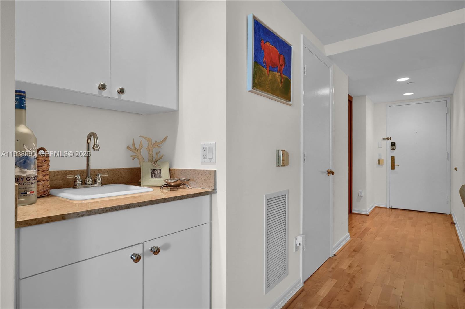 4779 Collins Avenue, Unit 3104 Miami Beach, FL 33140 - Photo 8 of 61 a en suite bathroom with a sink and mirror