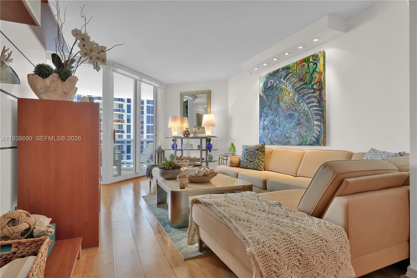 4779 Collins Avenue, Unit 3104 Miami Beach, FL 33140 - Photo 10 of 61 a living room with furniture and a large window