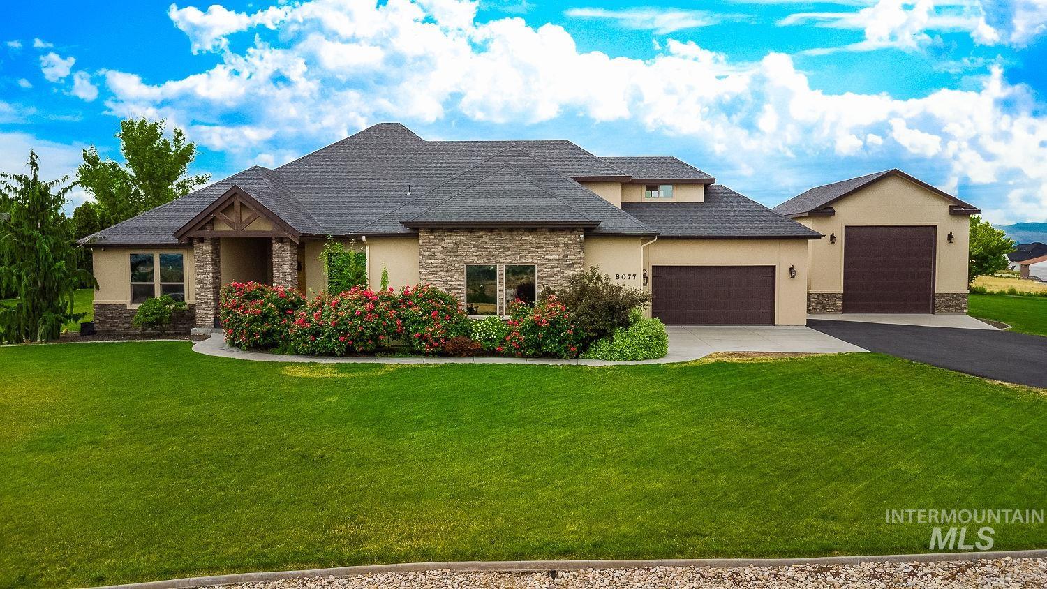8077 Star Pass Ridge Road Nampa, ID 83686 - Photo 2 of 37 Spacious backyard featuring an in-ground swimming pool, an expansive paver patio, a covered patio area, and mature landscaping