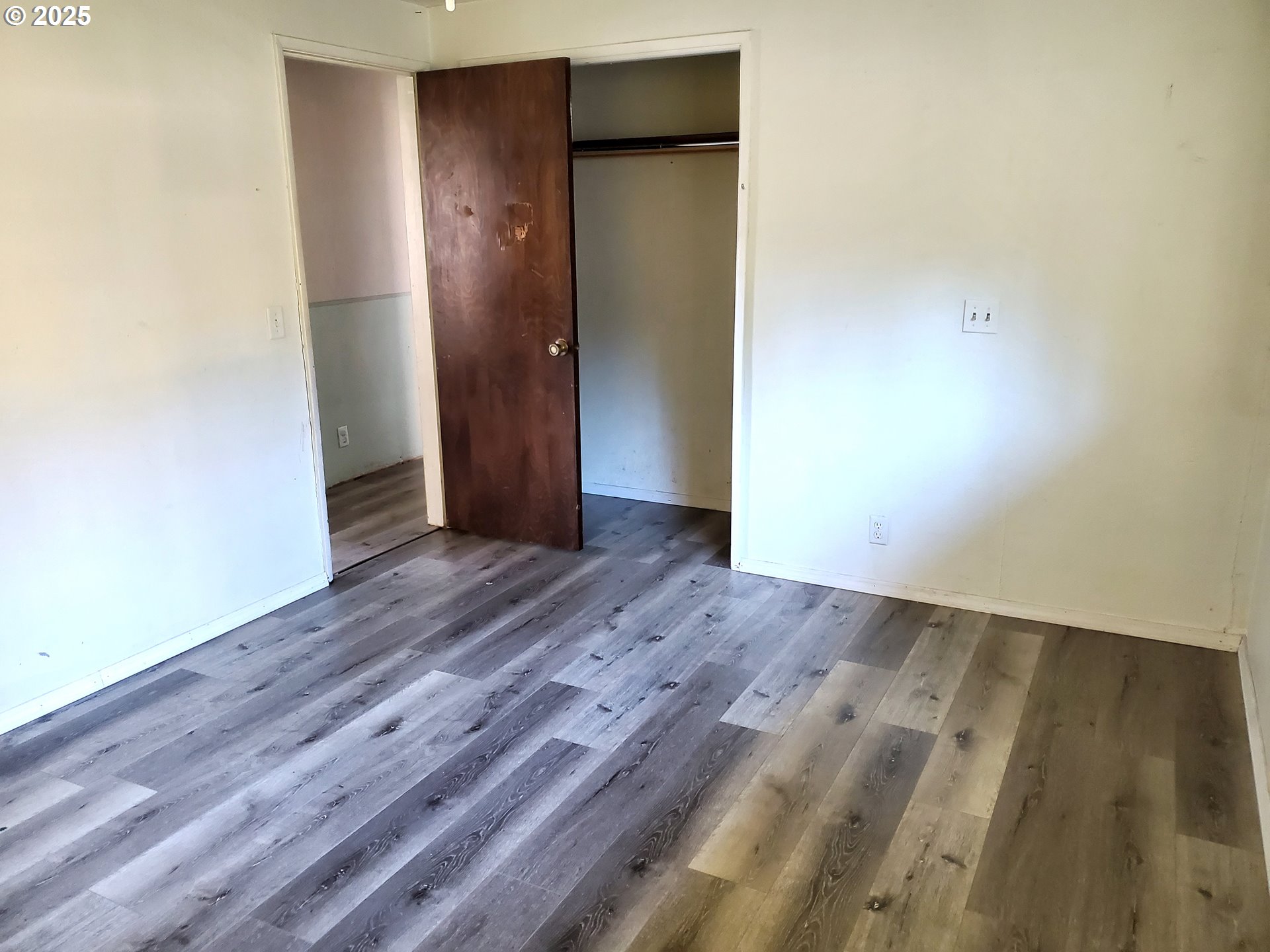 37186 Tree Farm Road Springfield, OR 97478 - Photo 13 of 37 a view of an empty room with wooden floor and closet